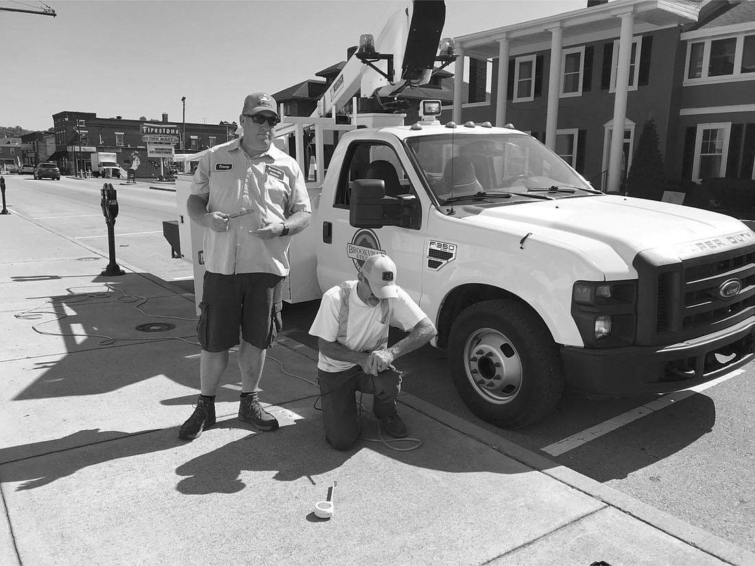 Rocky Sparks and Timmy Welke began installing the base plates for the bike racks on Monday July 10.