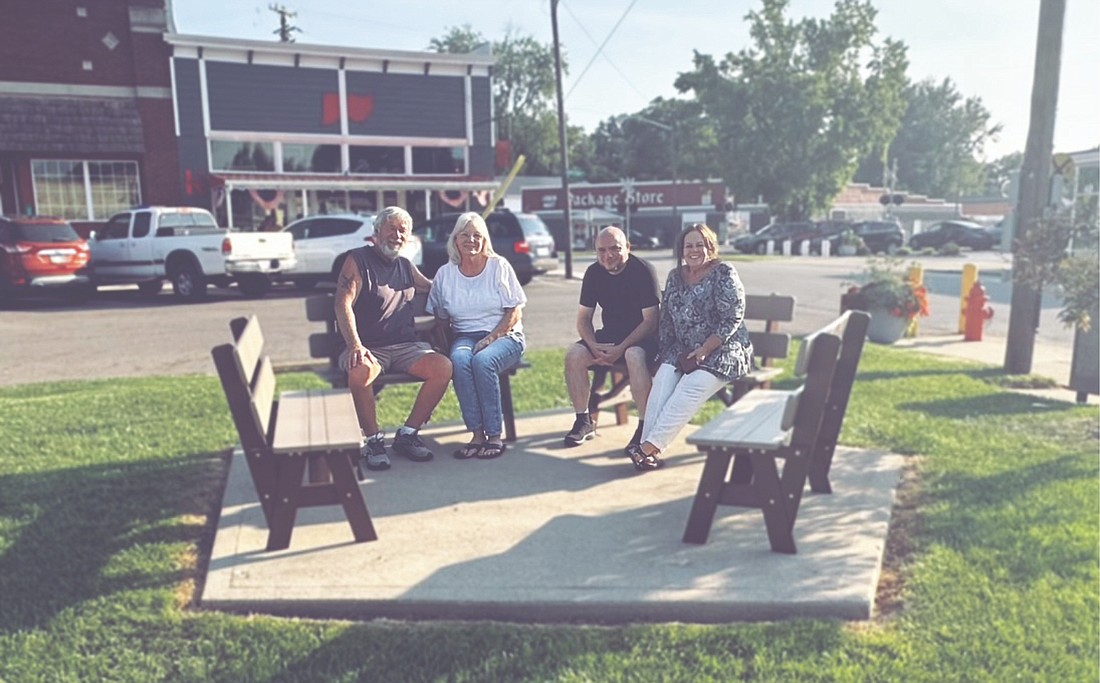 Greg and Robin Van Winkle, Cyrus Johnson, and Shannon Maddock discuss future plans for the College Corner Memorial Triangle.