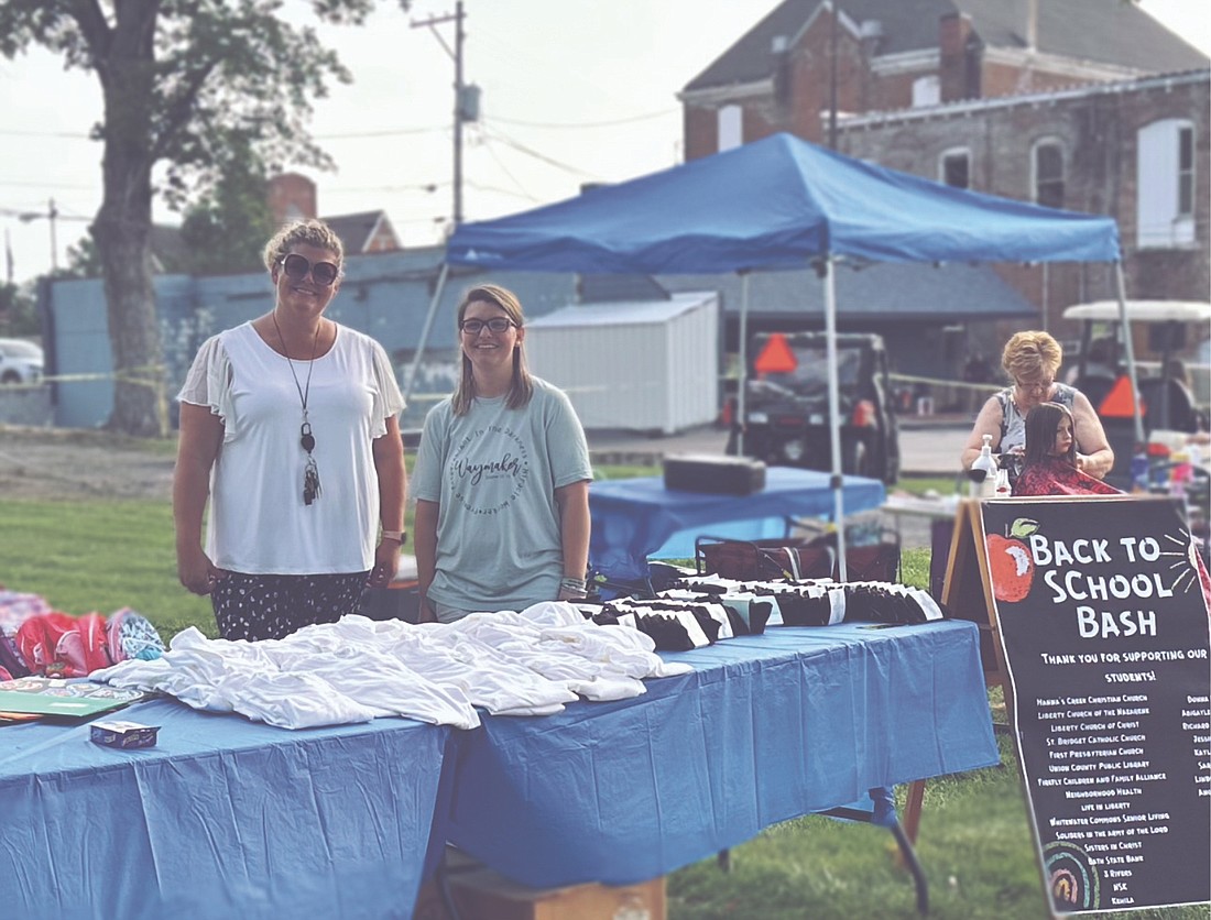 Lisa Gayhart (Left) and Brooke Murray at the school supply station in Liberty on Aug 2.