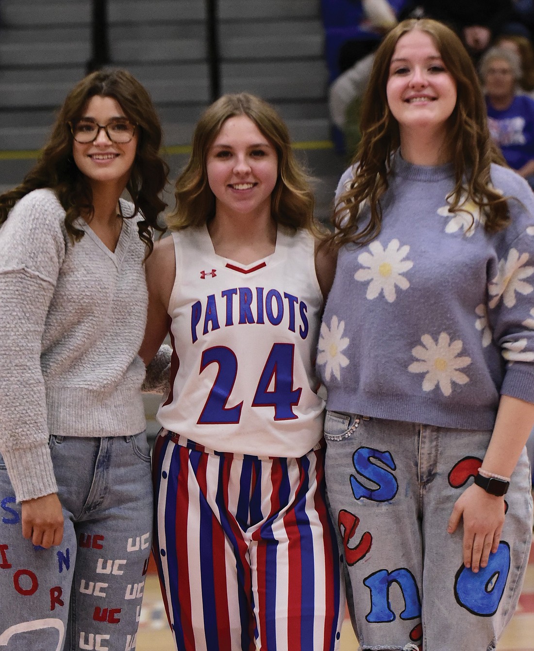 Whitney King is pictured with managers Calley Schenfeld (left) and Faith Coffey on senior night.
