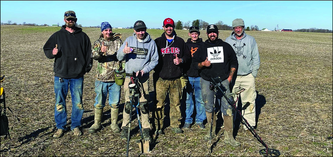 Adam Combs and his team metal detecting at a local farm.