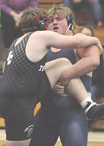 Wildcat wrestlers persevere over Trojans